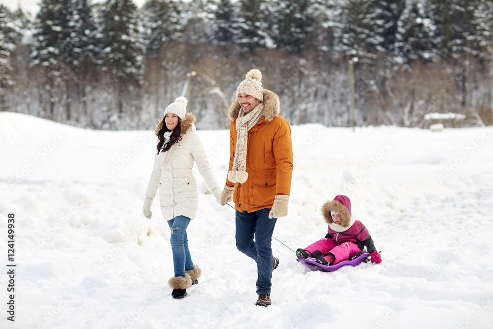 Obraz premium happy family with sled walking in winter forest