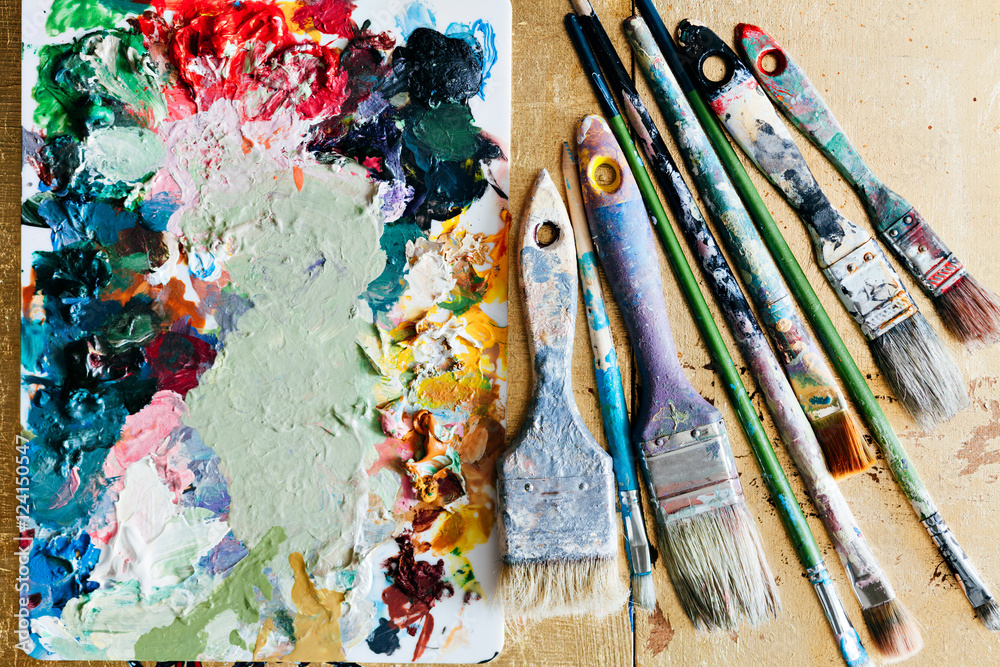 Fototapeta premium Brushes with palette in the creative background. Colorful element.