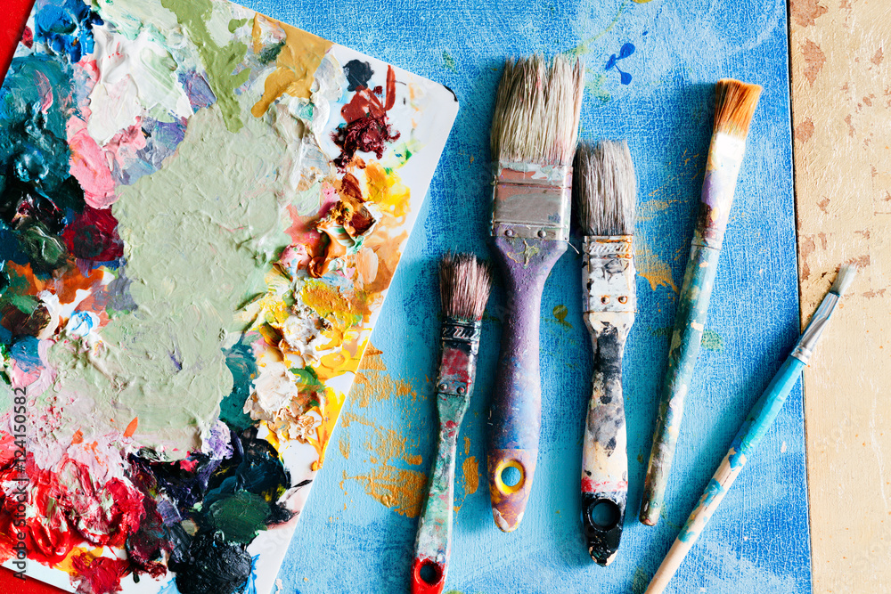 Brushes with palette in the creative background. Colorful element