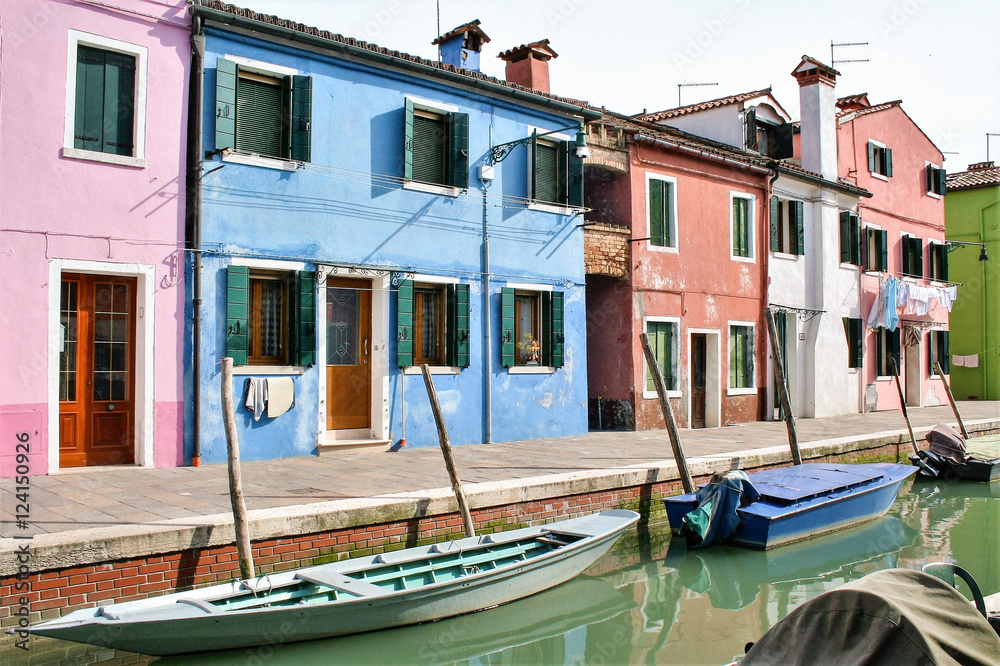 traditional colored houses by a canal of Burano island in the venetian lagoon, Venice, Italy