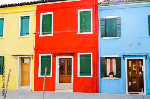 traditional colored houses by a canal of Burano island in the venetian lagoon, Venice, Italy