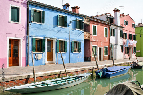 traditional colored houses by a canal of Burano island in the venetian lagoon, Venice, Italy