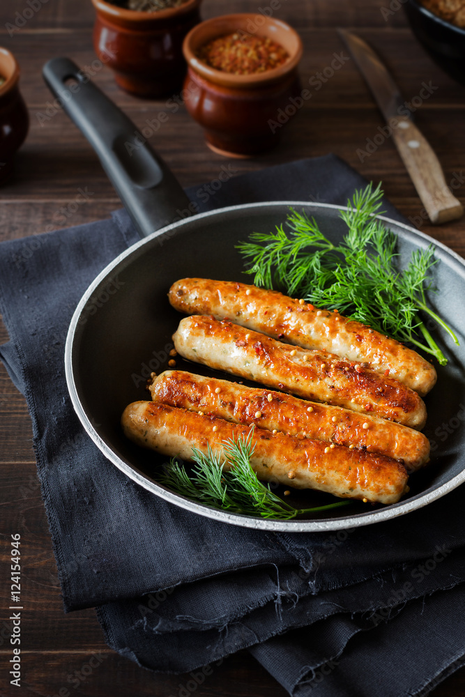 Pan of fried sausages with coriander