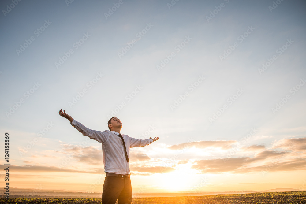 Thankful Businessman with Open Arms at the Field on sunset Thankful Businessman with Open Arms at the Field on sunset