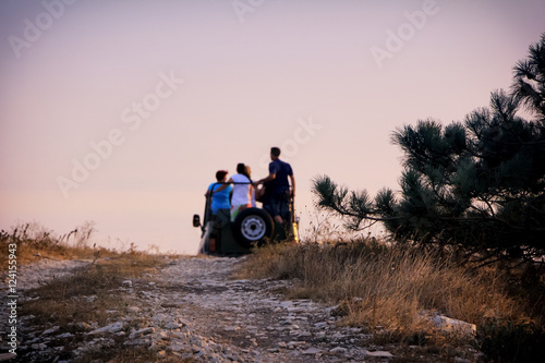 Rear view of a blurred group of tourists in jeep on safari