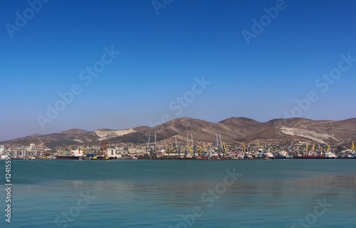Sea port with mountain landscape, blue sky