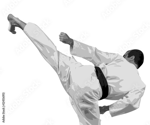 The sportsman in a kimono with a black belt does a high kick