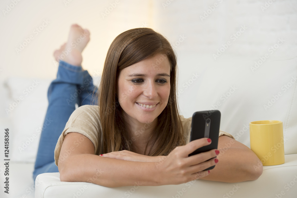 beautiful woman with coffee happy on couch networking on mobile phone relaxed beautiful woman with coffee happy on couch networking on mobile phone relaxed