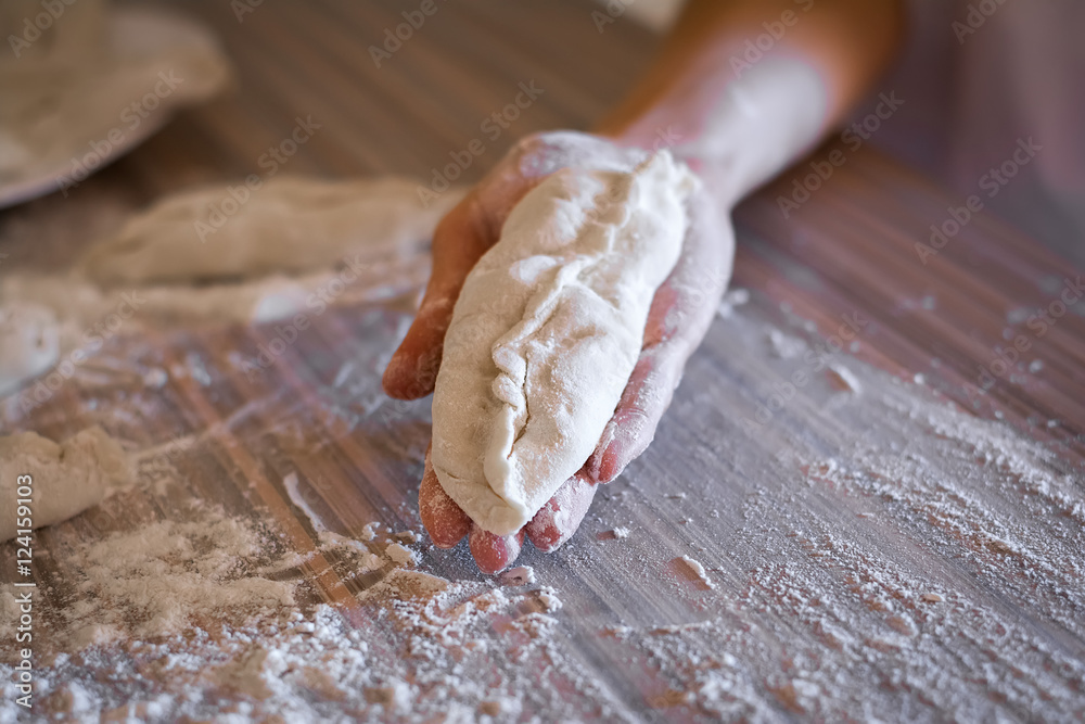homemade pie dough lays on a female hand