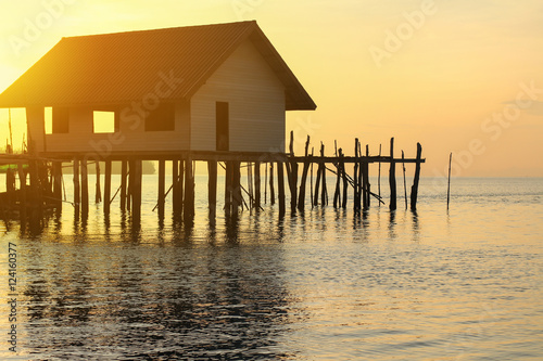 wooden house on sea sunset