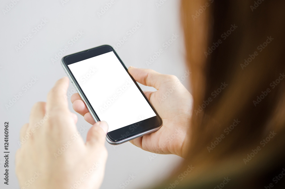 Close up hand holding black Mobile smart phone on white clipping path inside. Gray background. Rear view.