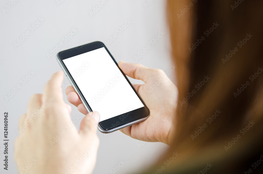 Close up hand holding black Mobile smart phone on white clipping path inside. Gray background. Rear view. Close up hand holding black Mobile smart phone on white clipping path inside. Gray background. Rear view.