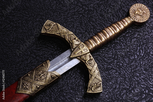 Ancient sword on a beautiful background photo