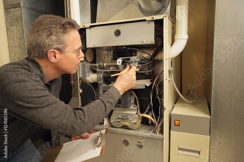 Repairman Checking A Furnace