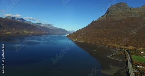 Cinema 4k 180 degree aerial of the autumn color mountains and water between elsnes, hatteng and oteren, in North Norway photo
