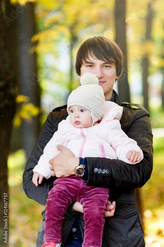 Photo of father with daughter in autumn park