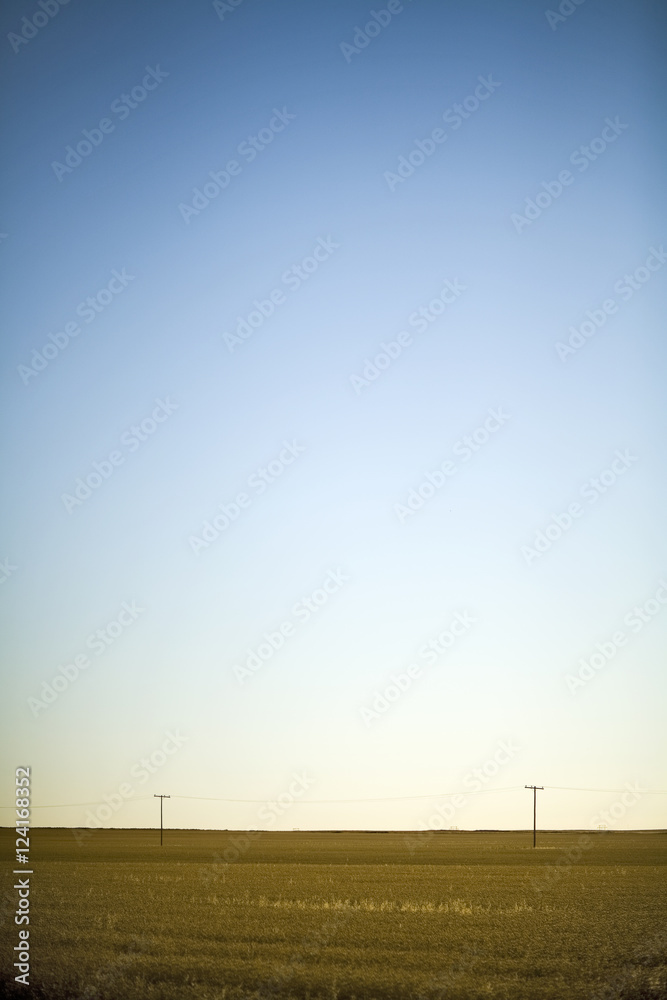 Hydro Electric Power Lines Across Field Are Dwarfed By Prairie Sky, Saskatchewan, Canada Hydro Electric Power Lines Across Field Are Dwarfed By Prairie Sky, Saskatchewan, Canada