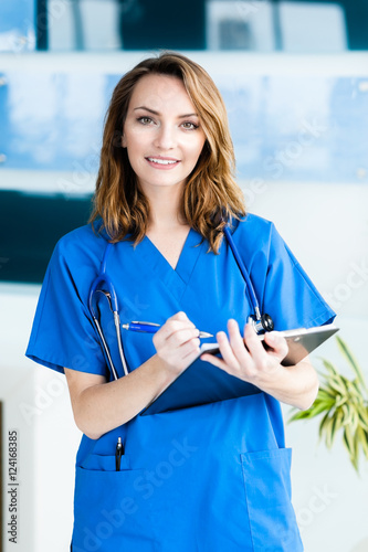 Young Woman Doctor Nurse in Hospital Clinic Office photo