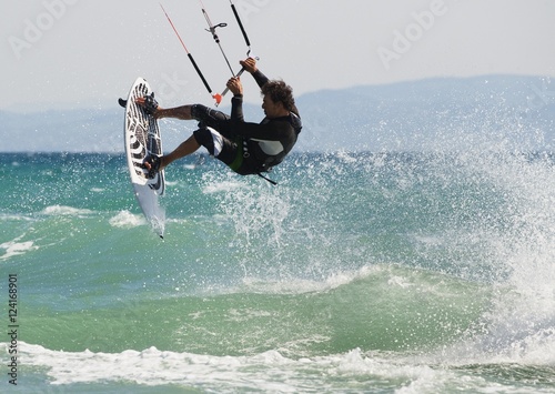 A Man Kitesurfing Off Dos Mares Beach In Front Of Hotel Dos Mares; Tarifa, Cadiz, Andalusia, Spain
