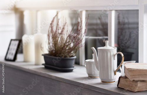 Grey wooden windowsill tightly decorated  photo