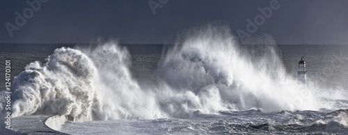 Waves crashing on lighthouse, Seaham, Teesside, England, UK photo