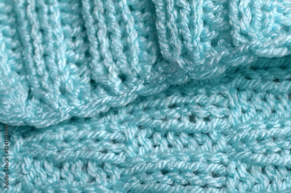 Piece of knitting work - blue yarn stitches - macro Piece of knitting work - blue yarn stitches - macro