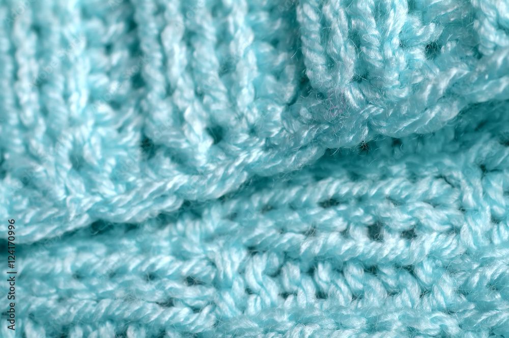 Piece of knitting work - blue yarn stitches - macro Piece of knitting work - blue yarn stitches - macro