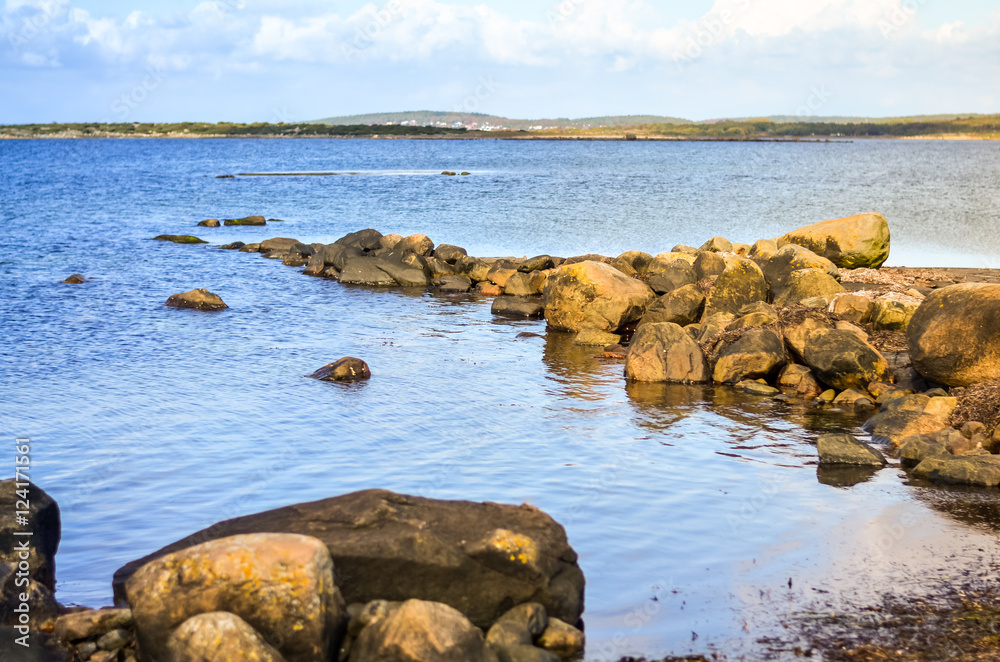 rocky sea shore with silent water in autumn landscape rocky sea shore with silent water in autumn landscape