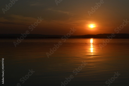 The sun over the river. Sunset on the river Volga. Solar path.