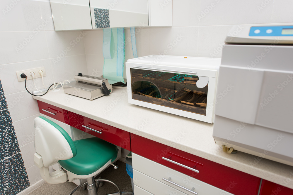 Sterilization room. Table with a packaging machine, ultraviolet shelf, sterilizer, autoclaving. Dentistry Sterilization room. Table with a packaging machine, ultraviolet shelf, sterilizer, autoclaving. Dentistry