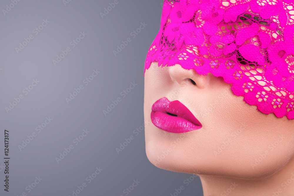 Fototapeta premium Woman with a pink blindfold on her face