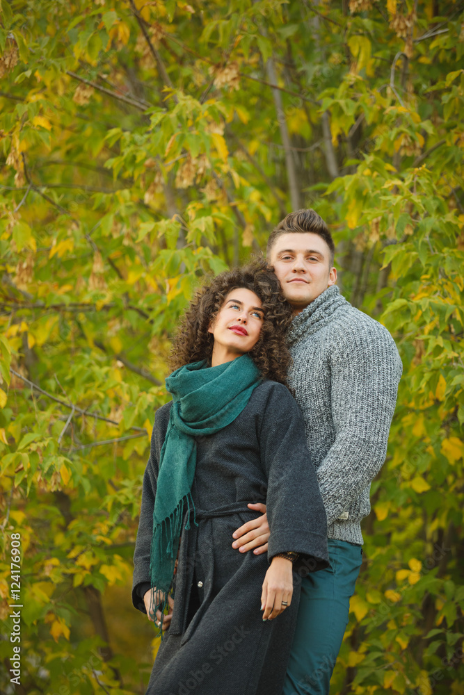 beautiful couple in the autumn forest. Curly girl beautiful couple in the autumn forest. Curly girl