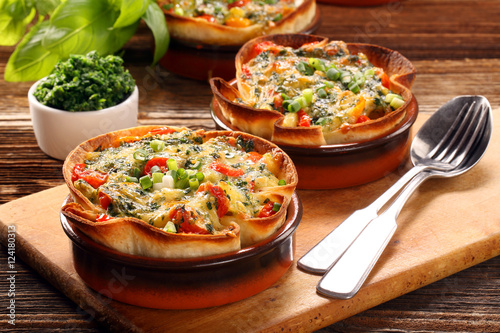Casserole with cheese, spinach and tomatoes