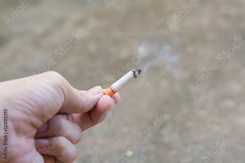 man hand smoking a cigarette..
