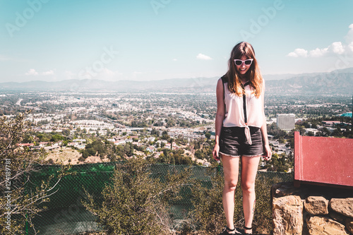 Girl at Hollywood Hills with panoramic view of Los Angeles photo