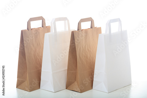 Brown and white paper shopping bags on white background