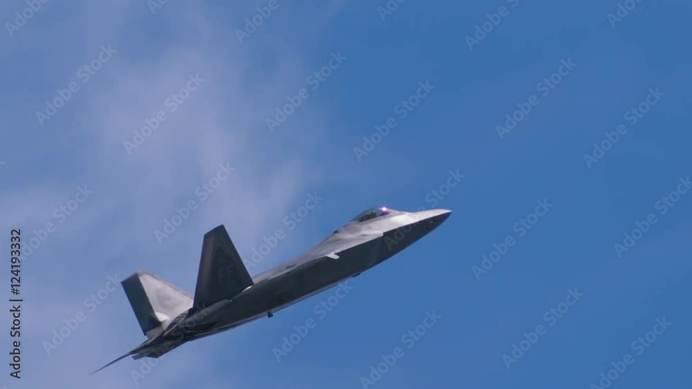 Tracking shot of fighter jet flying in blue sky Tracking shot of fighter jet flying in blue sky