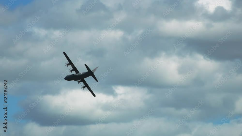 Slow motion of military aircraft flying in cloudy sky Slow motion of military aircraft flying in cloudy sky