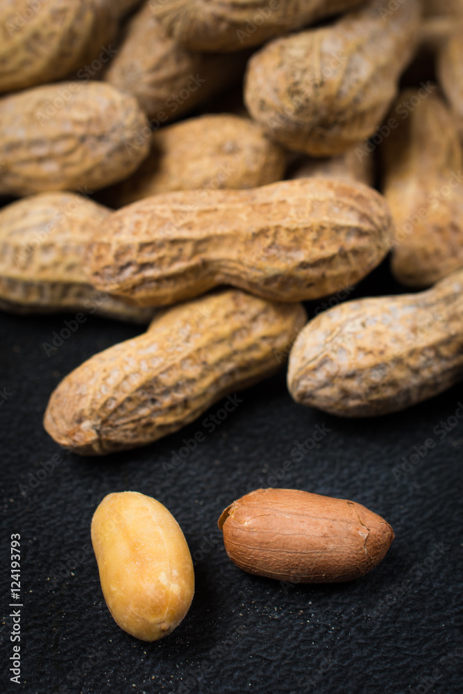 Two Peanuts without Shells Infront of Pile of Peanuts Close Up Two Peanuts without Shells Infront of Pile of Peanuts Close Up