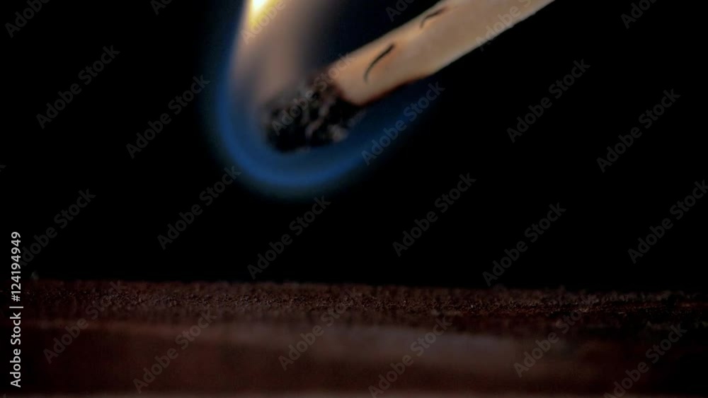 Firing point safety match. Close-up view to strike matches for matchbox. Detail of ignition matches for matchbox. Macro lighting of a match striking out a matchbox. Closeup safety match flame.