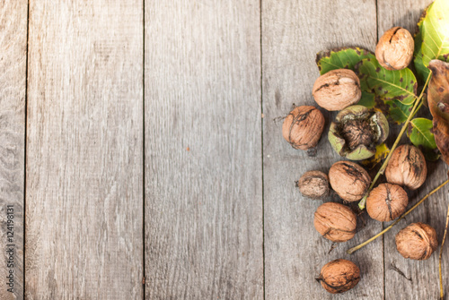 walnut on wooden background with leaves