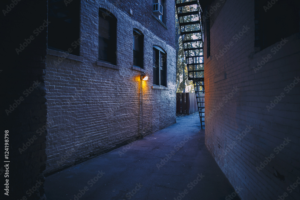 burning lantern in a dark alleyway. city backyards