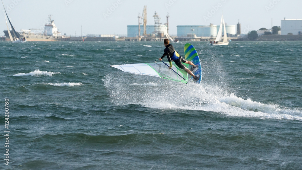 Fototapeta premium Windsurfer catching a wave