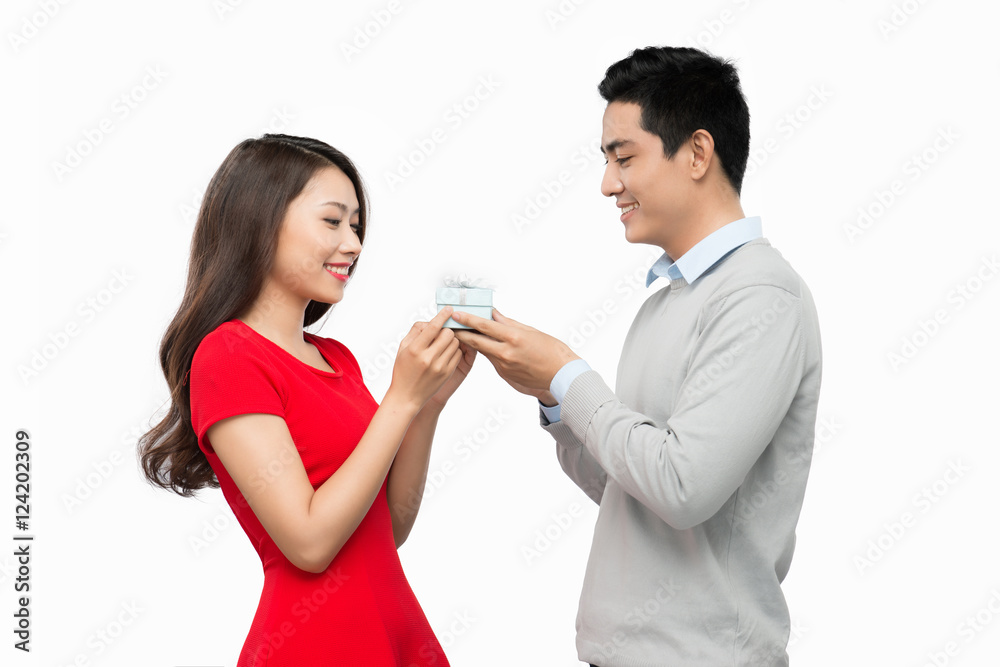 Man makes present to his lovely sweetheart. Young man giving a g Man makes present to his lovely sweetheart. Young man giving a g