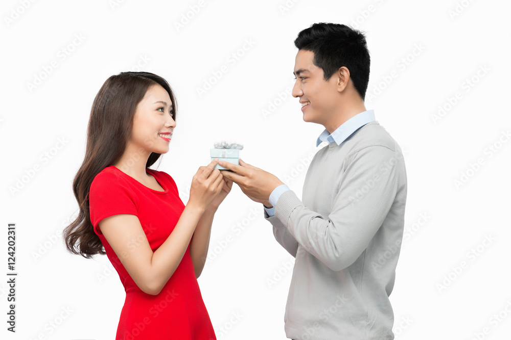 Man makes present to his lovely sweetheart. Young man giving a g Man makes present to his lovely sweetheart. Young man giving a g