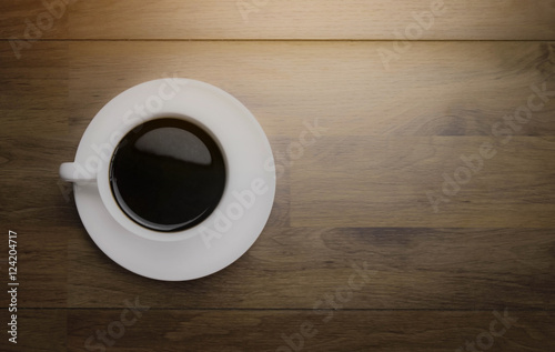 Black coffee with top view and space for note on wooden background,vintage style