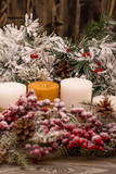 Christmas decorations, fir branch in snow, candle on wooden background