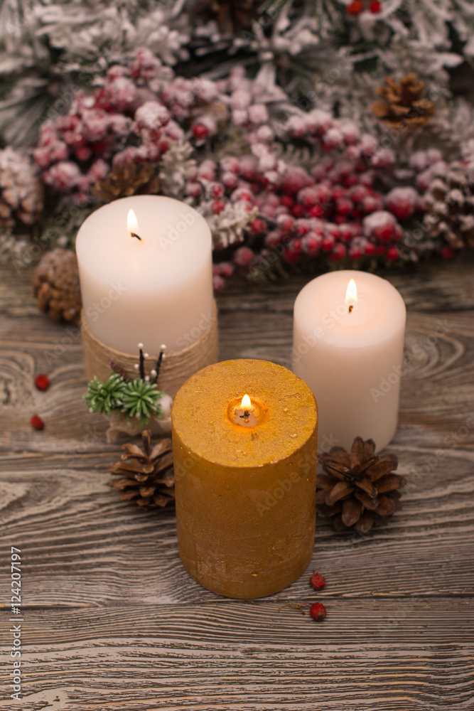 Fir branch in snow, lighted candle, cone on wooden background. Christmas theme Fir branch in snow, lighted candle, cone on wooden background. Christmas theme