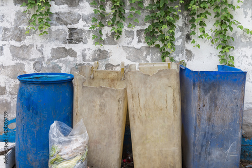Garbage bags with food waste at dumpsters © uppichaya