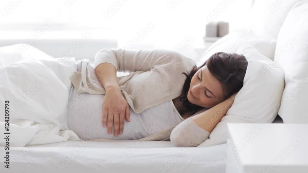 happy pregnant woman touching her tummy at home 55 happy pregnant woman touching her tummy at home 55